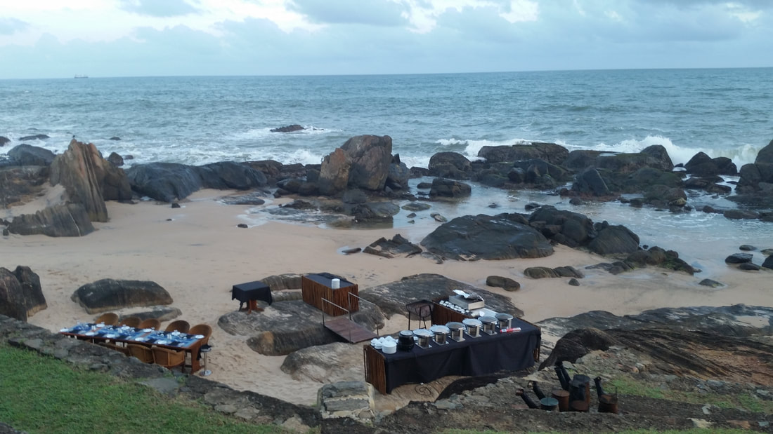 Tables and BBQ set up for evening seafood BBQ on the beach at Galle